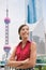 Business in China - chinese businesswoman confident looking at Shanghai skyline in Pudong financial district. Young professional