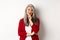 Business concept. Asian mature businesswoman smiling pleased, looking thoughtful, having an idea, standing in red blazer