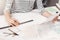 Business concept. Close up detail of young successful architect entrepreneur in striped clothes sitting at white table