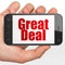 Business concept: Hand Holding Smartphone with Great Deal on display