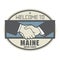 Business concept with handshake and the text Welcome to Maine, U