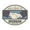 Business concept with handshake and the text Welcome to Michigan