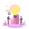 Business concept for launching ideas, light bulb is shining. Tiny little men launch an idea, light bulb is shining appears an idea