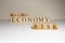 Business concept. Macro, economy, risk words are written with wooden cubes