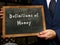 Business concept meaning Definitions of Money with sign on the black chalkboard