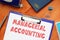 Business concept meaning MANAGERIAL ACCOUNTING with sign on the sheet
