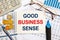 Business concept - notebook writing GOOD BUSINESS SENSE