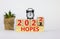 Business concept of planning 2022 hopes symbol. Turned a wooden cube and changed words `Hopes 2021` to `Hopes 2022`. Beautiful