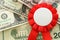 Business concept of red rosette over dollar bills. Success, Best Investment and reward for Performance