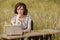 Business concept shot of a beautiful young woman sitting at a desk using a computer in a field.