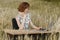 Business concept shot of a beautiful young woman sitting at a desk using a computer in a field.