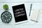 Business concept. Top view of plant,clock,pen,notebook and tablet written with Limited Liability Company on white wooden.