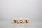 business concept. wooden cube on a concrete surface with text SQL