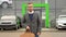 Business, confident stylish man stands with a bag near a car dealership before buying a new car