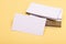 Business contacts concept. Business cards stack on yellow background. Name cards in white