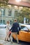 Business couple entering a cab in the street