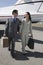 Business Couple Walking Together At Airfield