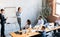 Business Coworkers Presenting Startup Idea To Colleagues Standing In Office