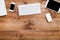 Business devices on wooden desk modern office background, top view