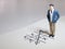 Business and direction concept. Businessman small figure standing on paper and center of circle with more arrows point to many di