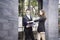 Business discussions between Caucasian people. Business people are talking and smiling while standing on stair of the office