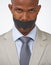 Business doesnt like whistle blowers. Studio portrait of an african american businessman with his mouth covered by tape.