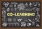 Business doodle about co learning on chalkboard.