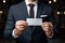 Business elegance Close up of a man in a suit showcasing a business card mockup