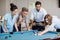 Business executive taking picture with mobile phone while colleagues playing pool