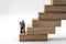 Business and Family Concept. Man and Woman parent and child miniature figure people standing on stack of wooden block on white