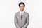 Business, finance and career concept. Portrait of professional handsome young asian man in grey suit and tie, look