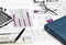 business financial chart analysis with pen, eyeglasses, calculator & notebook