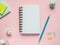 Business flat lay with copy space on a background pink Notebooks to write text stickers Pencil