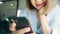 Business freelance Asian woman using smartphone for talking, reading and texting while sitting on table in cafe. Lifestyle smart