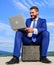 Business on fresh air. Businessman with laptop sit briefcase blue sky background. Modern technologies portable device