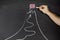 Business goal and success concept. Businessman drawing flag and mountain on chalkboard