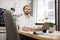 Business guy in stylish formal shirt posing at own modern office.