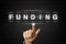 Business hand clicking funding on Flipboard