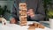 Business hand playing tower wooden blocks game