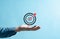 Business hands holding target icon, dartboard and arrow for creative and set up business objective target goal, marketing solution