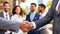 Business handshake of a businessman in front to the partners