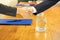 Business handshake at conference room with glass water on wooden table.