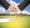 Business handshake on golf course.