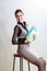 Business ideas. Portrait of Optimistic Caucasian Brunette Businesswoman Posing with Folders Indoors