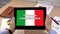 Business Italian application against flag on tablet in female hands, tutorial