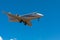 Business jet airplane flying on a high altitude above the blue cloudless sky.