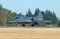 Business jet taking off runway at golden hour