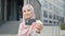 Business lady in hijab with credit card and smartphone making purchases outdoors. Blur background of women. Focus on