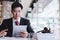 Business lawyers using cell phone for contact customer with brass scale on wooden desk in office.