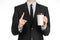 Business lunches coffee theme: businessman in a black suit holding a white blank paper cup of coffee with a brown plastic cap isol